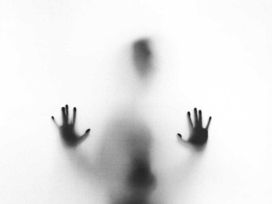 person, outside blurry window, hands, head, black and white